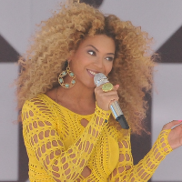 powerful woman Beyonce with microphone smiling