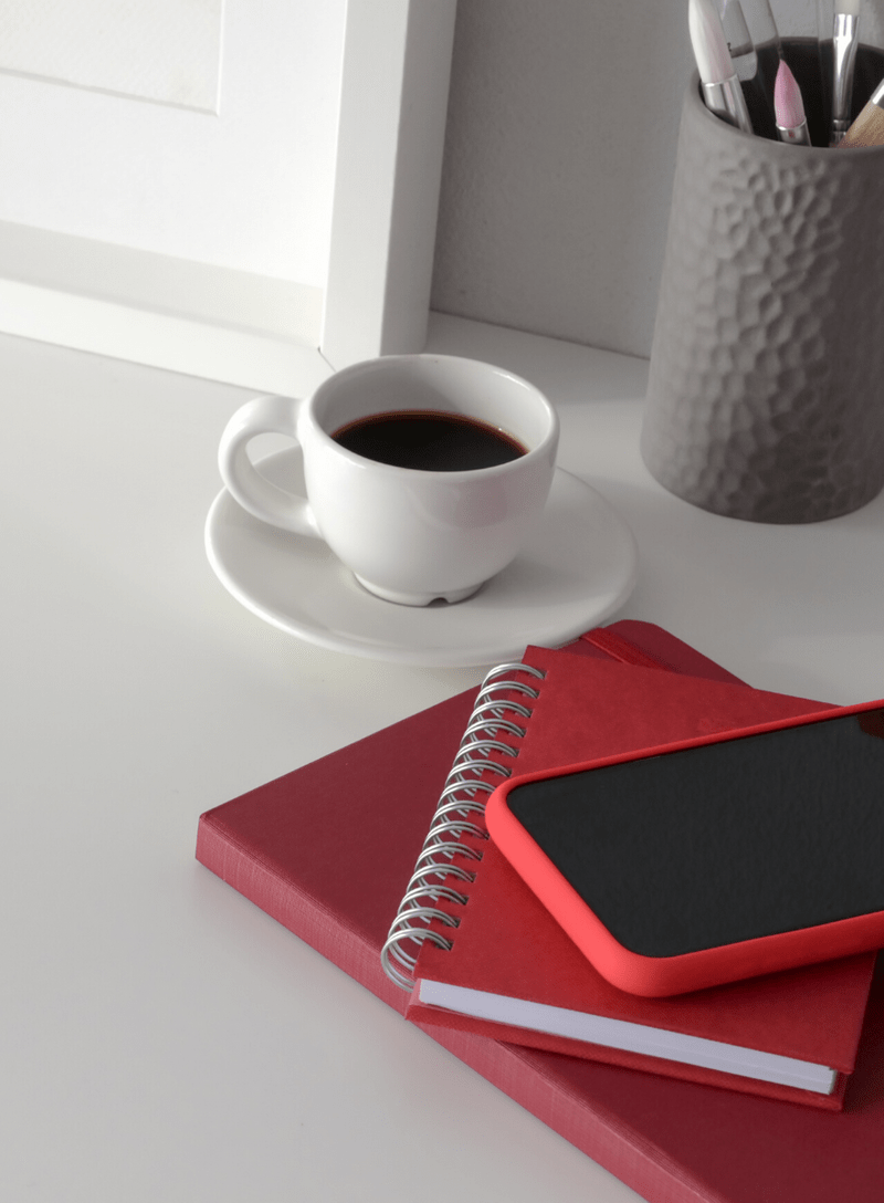 market research Red book, notebook and phone on work table with coffee